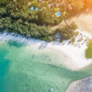 Въздушен изглед към тропически плаж с тюркоазени води и зеленина