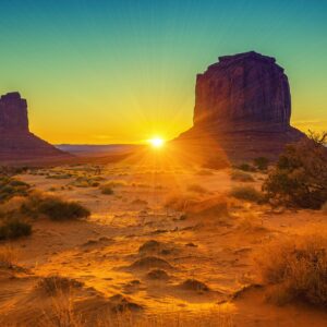 Залез над монументални скали в пустинята.