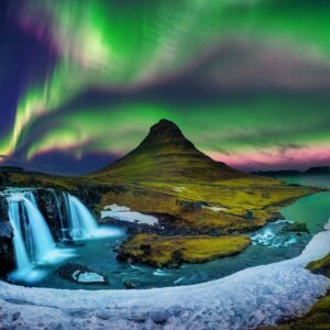 Северното сияние над Киркюфел и водопад в Исландия.