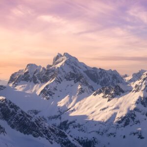 Алпийски върхове със сняг при залез.