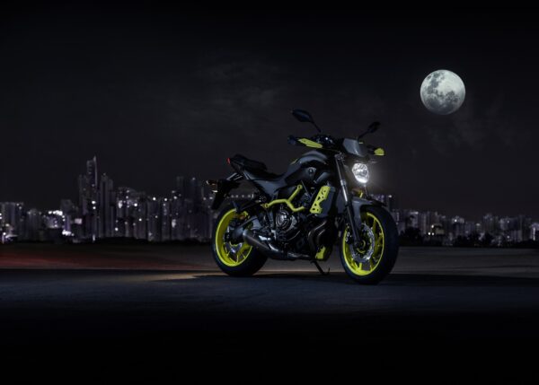 Мотоциклет Yamaha MT с жълти джанти на нощен градски фон