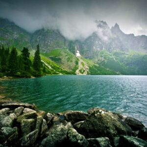 Езеро с мъгливи планини в далечината