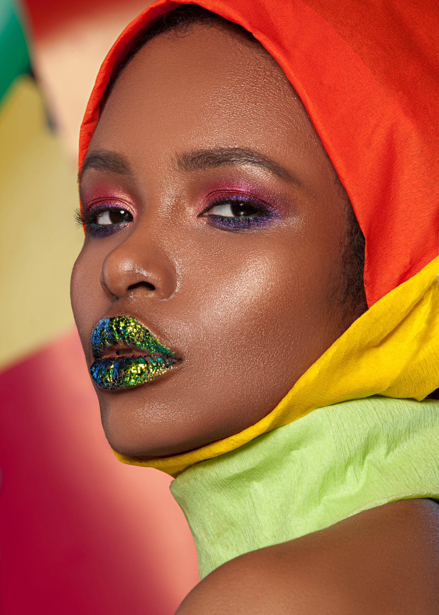 Woman with colorful makeup and scarf.