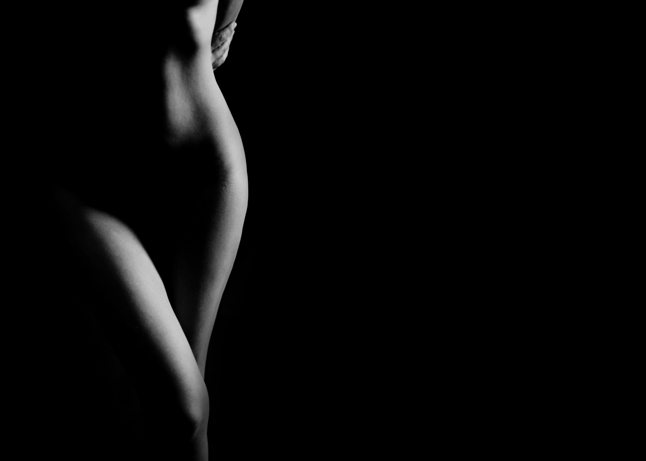 Elegant black and white photo of a female silhouette in minimalist style.