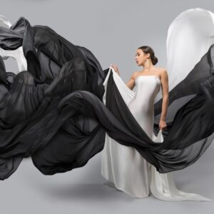 Modern black and white photo of a woman with flowing veils in elegant composition.